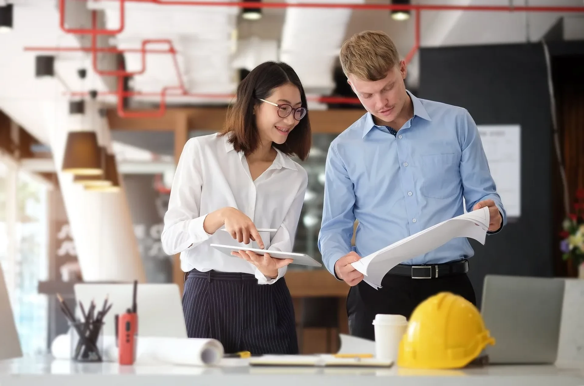 Architect and engineer working with technology