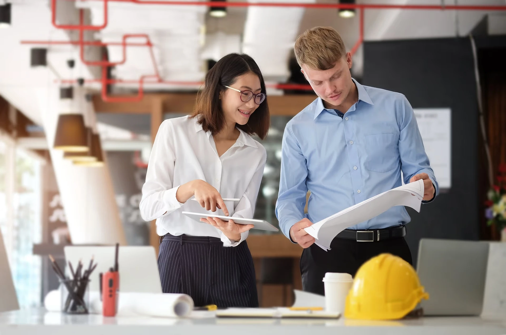 Architect and engineer working with technology